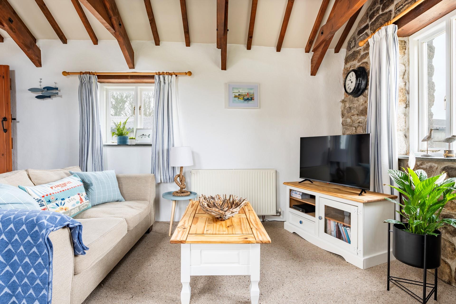 The sitting room is decorated with pastel decor and is a comfortable base to come back to.