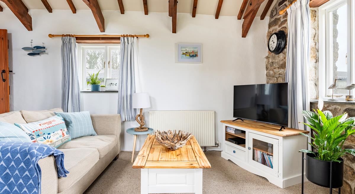 The sitting room is decorated with pastel decor and is a comfortable base to come back to.