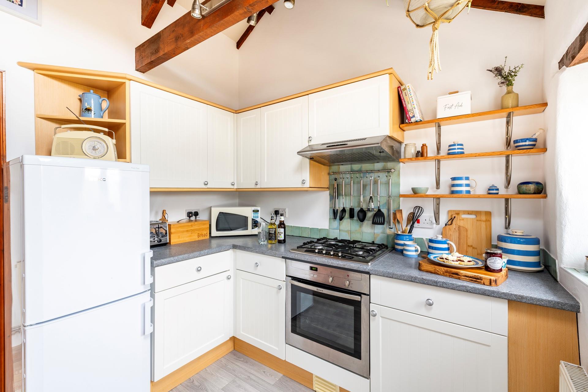 The kitchen is well-equipped for rustling up romantic meals and packing day trip picnics.