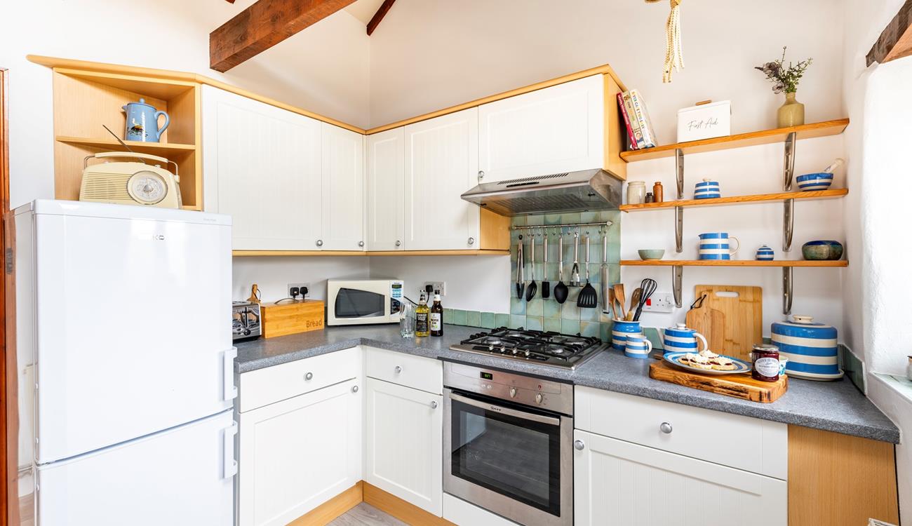 The kitchen is well-equipped for rustling up romantic meals and packing day trip picnics.