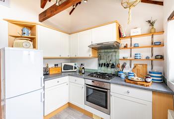 The kitchen is well-equipped for rustling up romantic meals and packing day trip picnics.