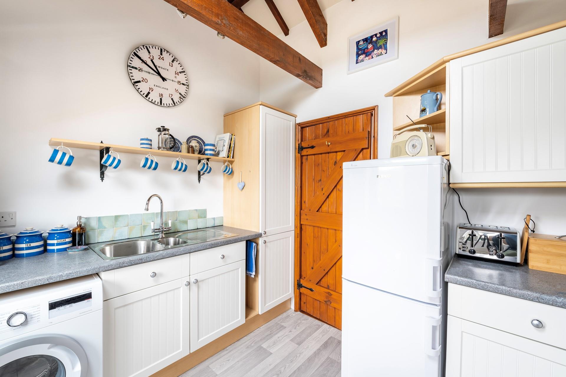 The fully equipped kitchen has matching crockery for the perfect afternoon tea.