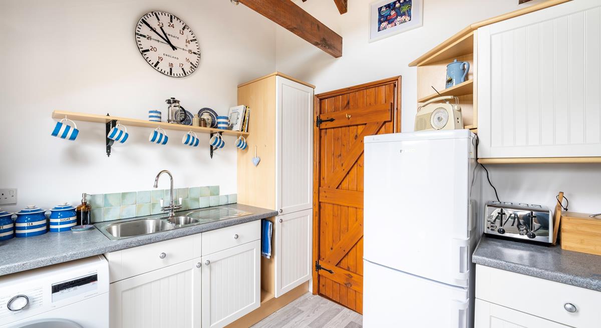 The fully equipped kitchen has matching crockery for the perfect afternoon tea.