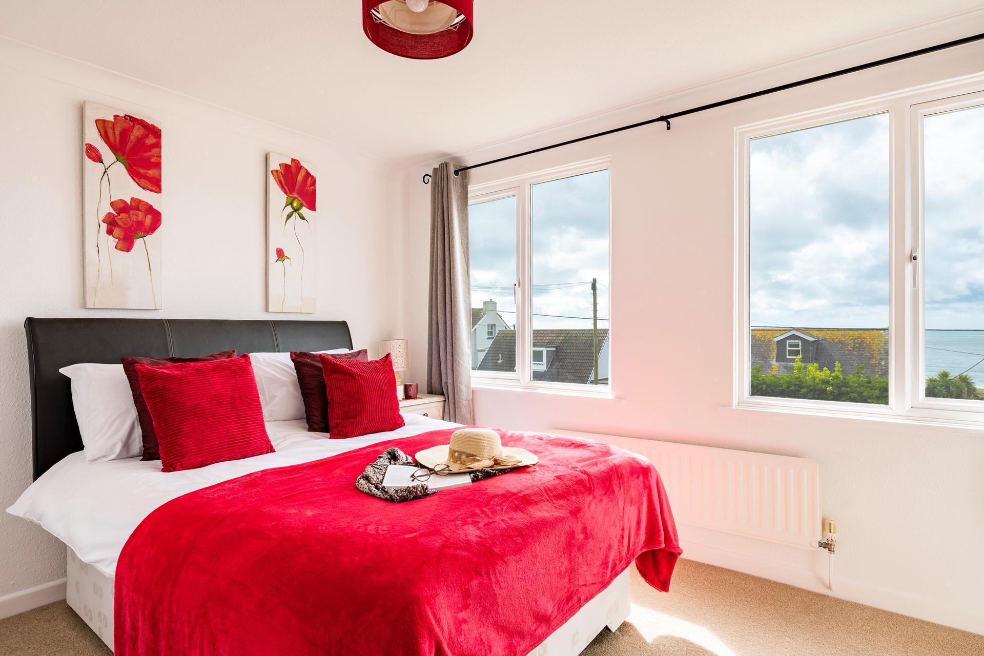 Bedroom 2 has a double bed and is decorated in bright red.