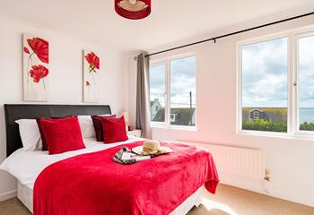 Bedroom 2 has a double bed and is decorated in bright red.