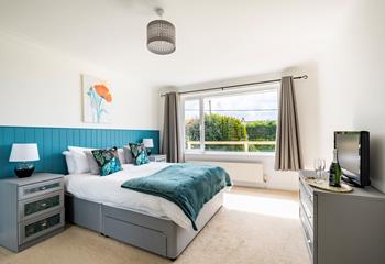 Bedroom 1 is decorated with ocean blue colours reflecting the close proximity to the sea.
