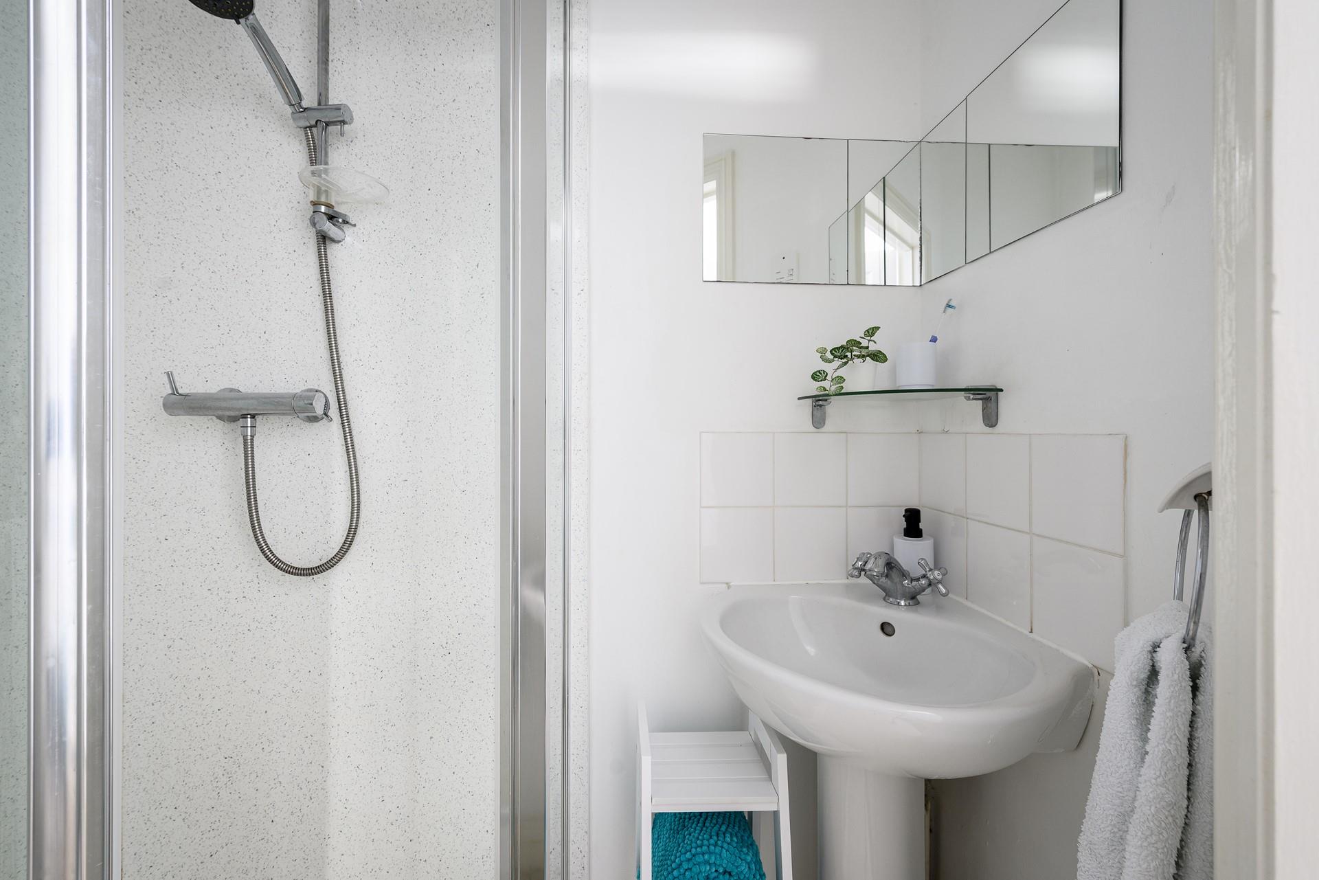 Wash off sandy toes in the shower after a day on Porthmeor.