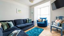 The sitting room is perfect for relaxing evenings after busy days exploring.