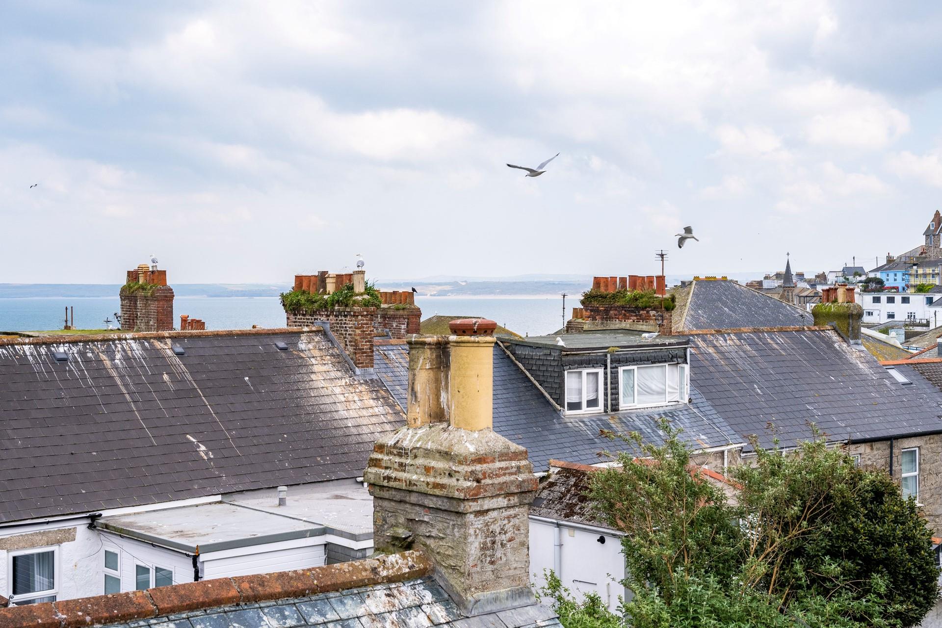 Enjoy sea views over St Ives' quirky rooftops.