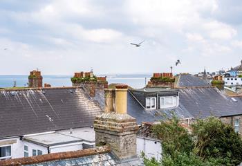 Enjoy sea views over St Ives' quirky rooftops.