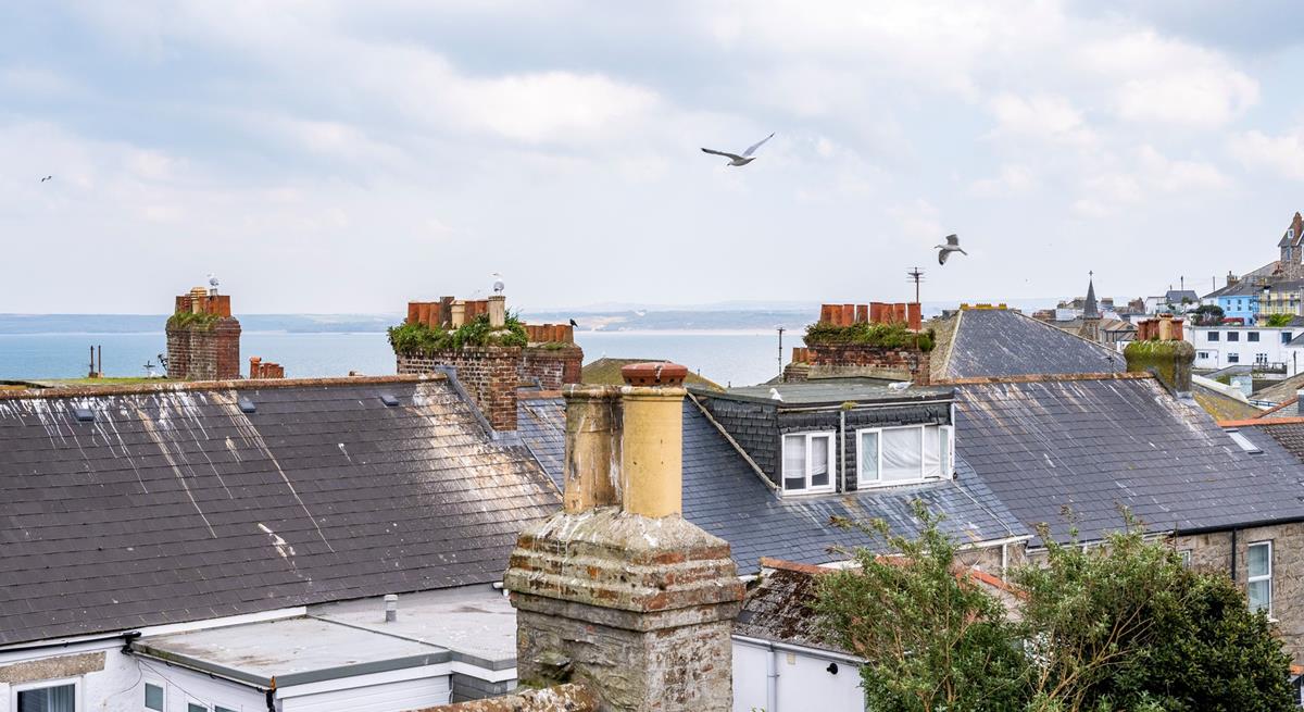 Enjoy sea views over St Ives' quirky rooftops.