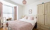 Pastel tones in the bedroom make a calming space to relax each night. - Thumbnail Image