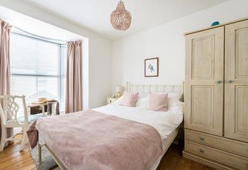 Pastel tones in the bedroom make a calming space to relax each night.
