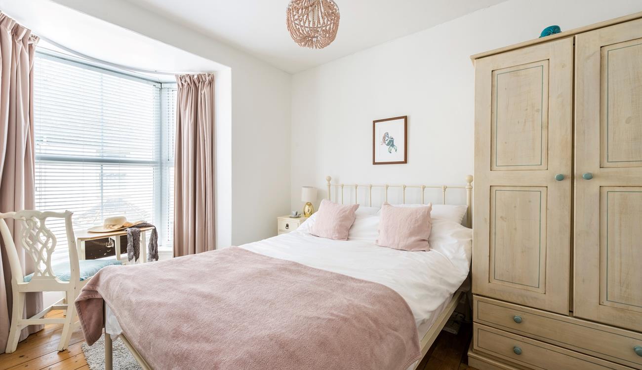 Pastel tones in the bedroom make a calming space to relax each night.