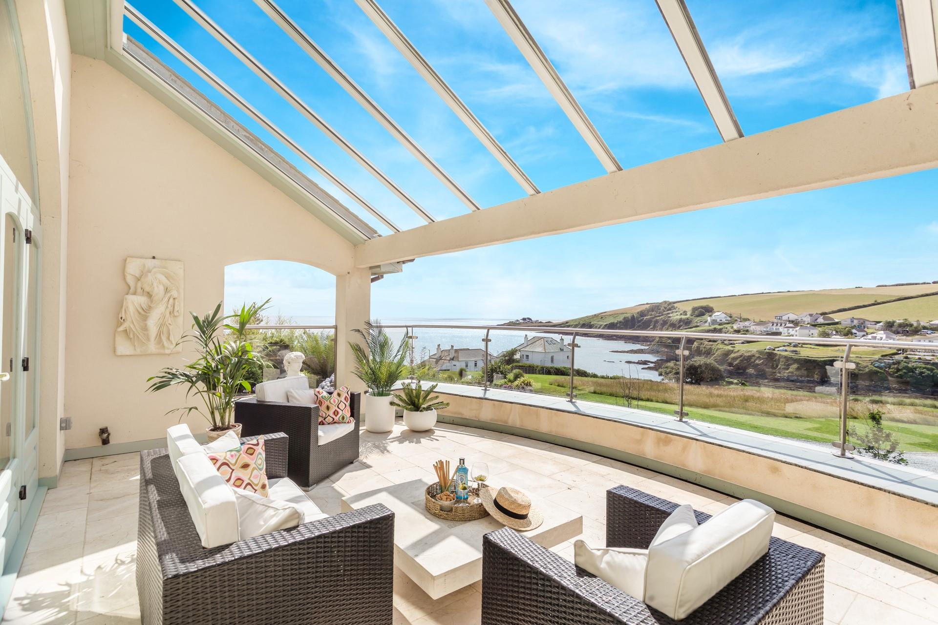 The large balcony offers stunning views of Portmellon and beyond.