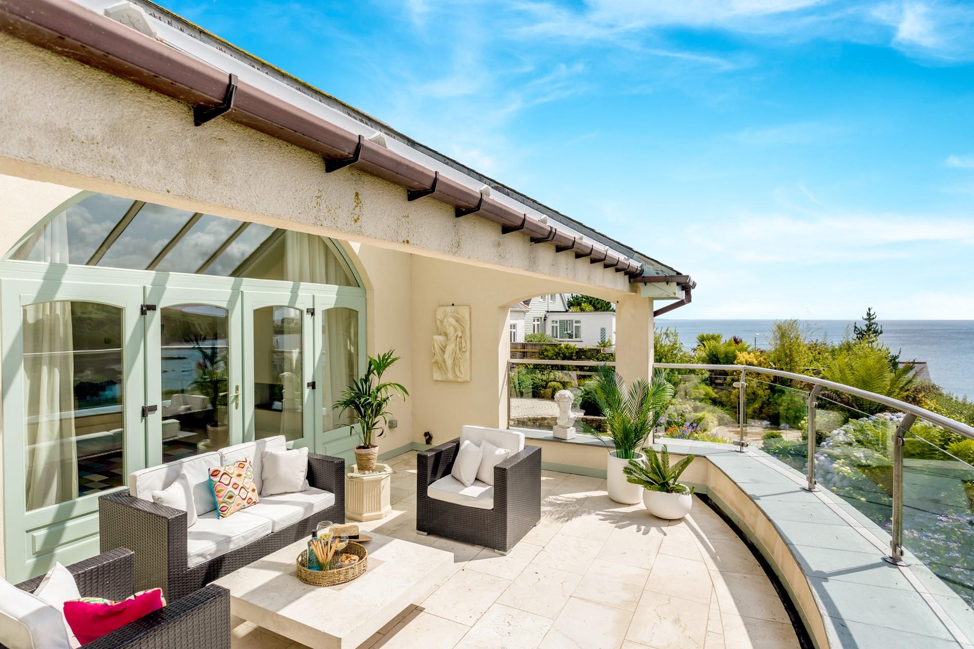 The comfortable rattan furniture is perfect for al fresco evenings watching the sun go down.