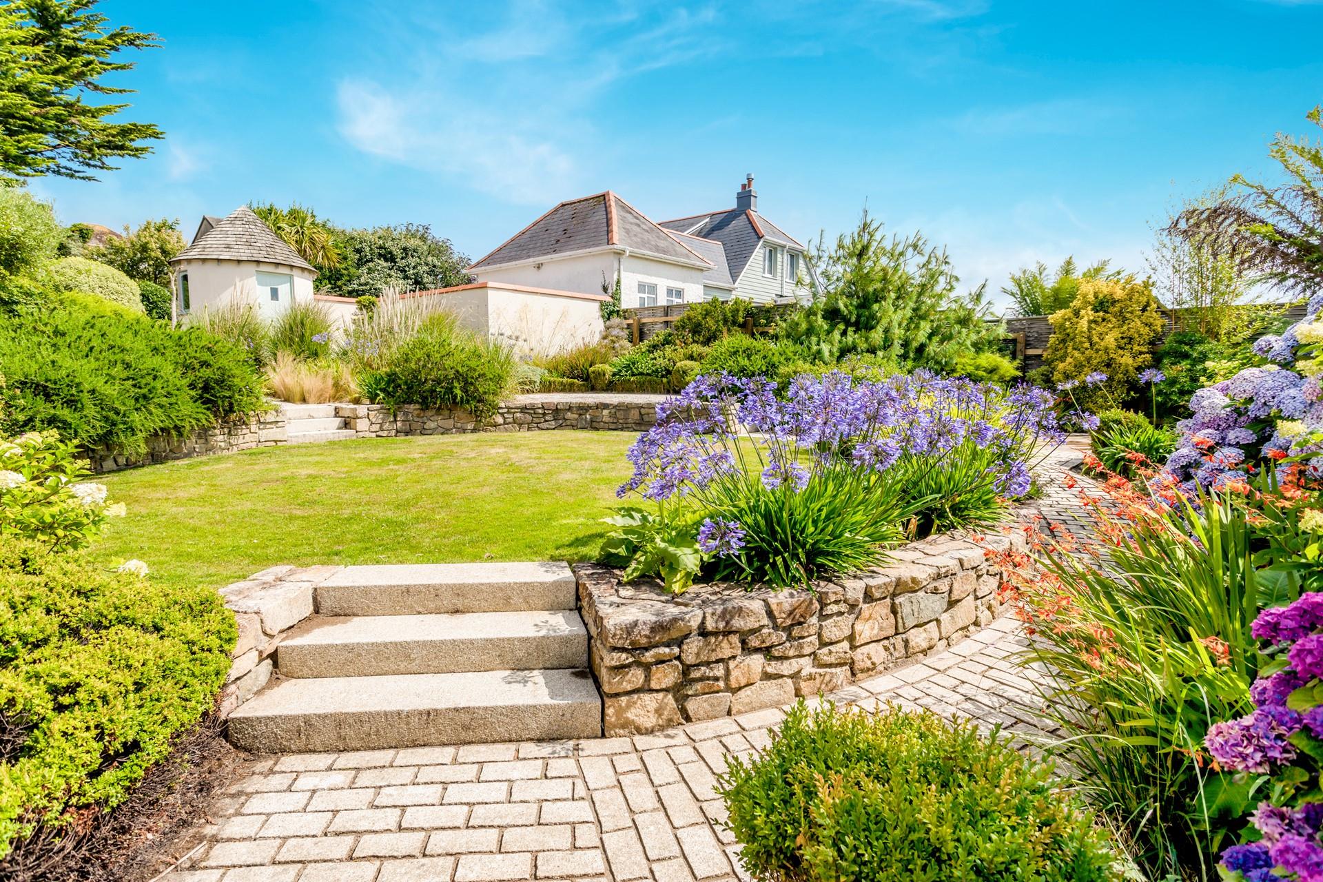 Weave through the bursting colours in the landscaped gardens to reach Pip House.