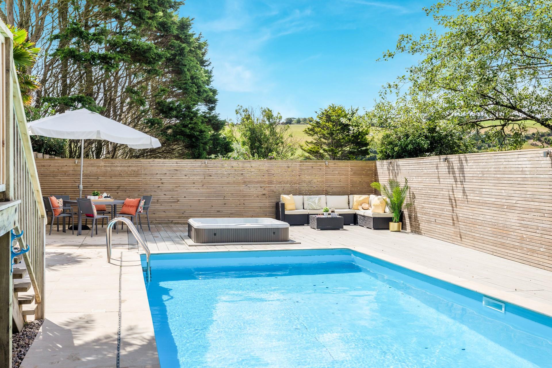 Unwind in the bubbling hot tub soaking up the sun.