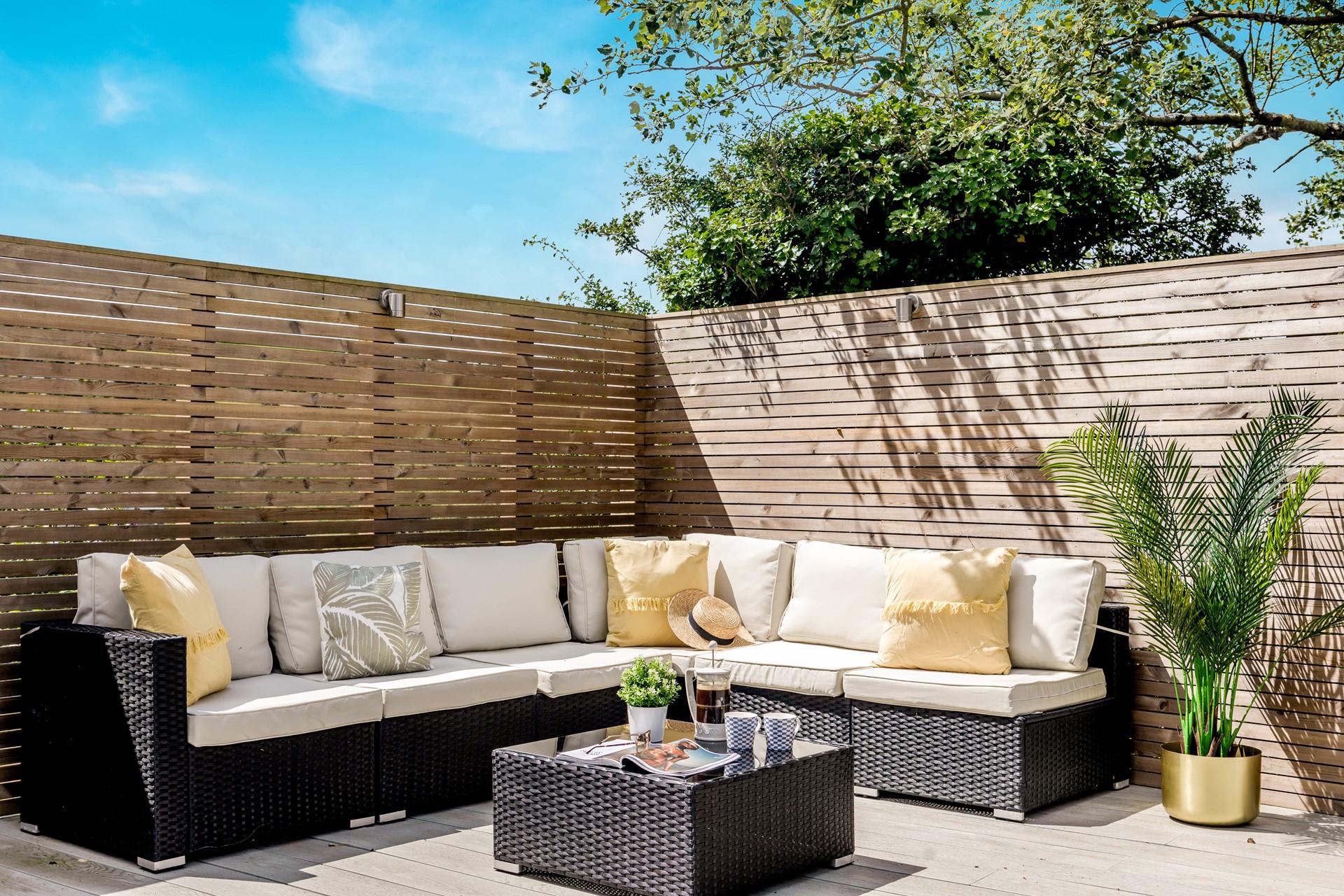The L-shaped rattan furniture is perfect for lounging about in the sun.