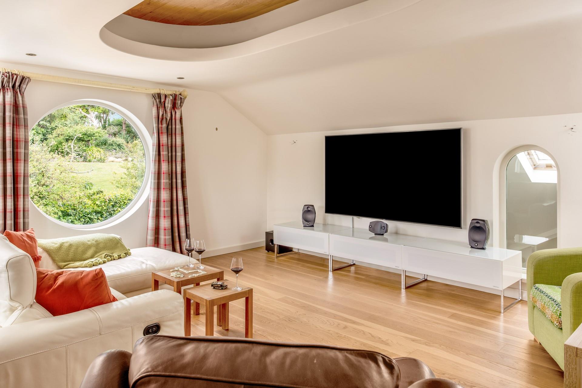 Gather the family around in the cinema room and enjoy a film on the 84-inch TV!