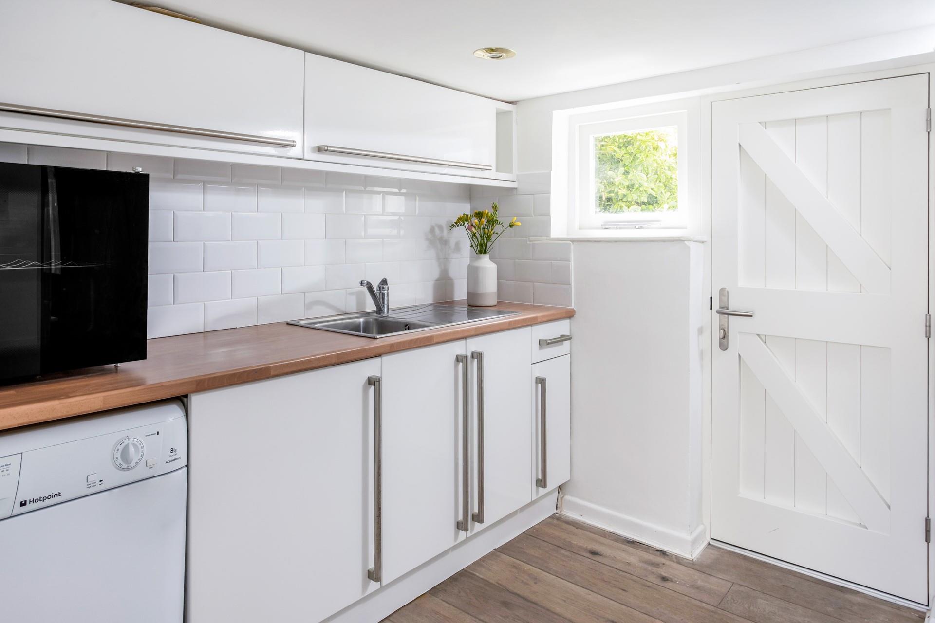 The utility room has a washing machine, tumble dryer and the added bonus of a wine cooler.