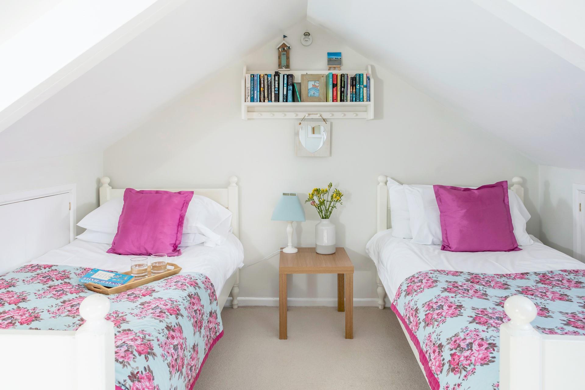 Bedroom 4 is on the upper landing of the first floor and has twin beds.