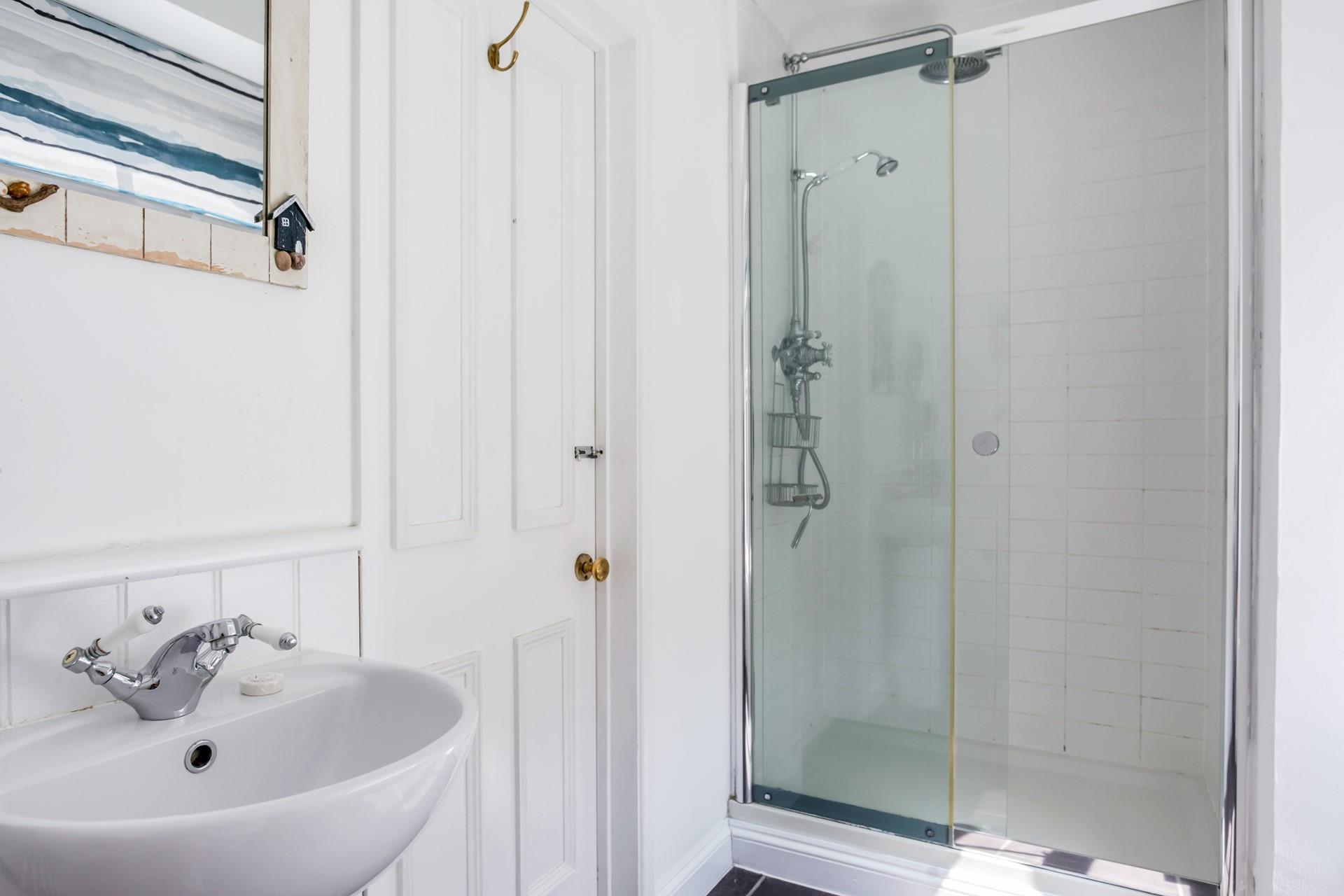 Wash off sandy toes in the shower after a day on the beach just around the corner.