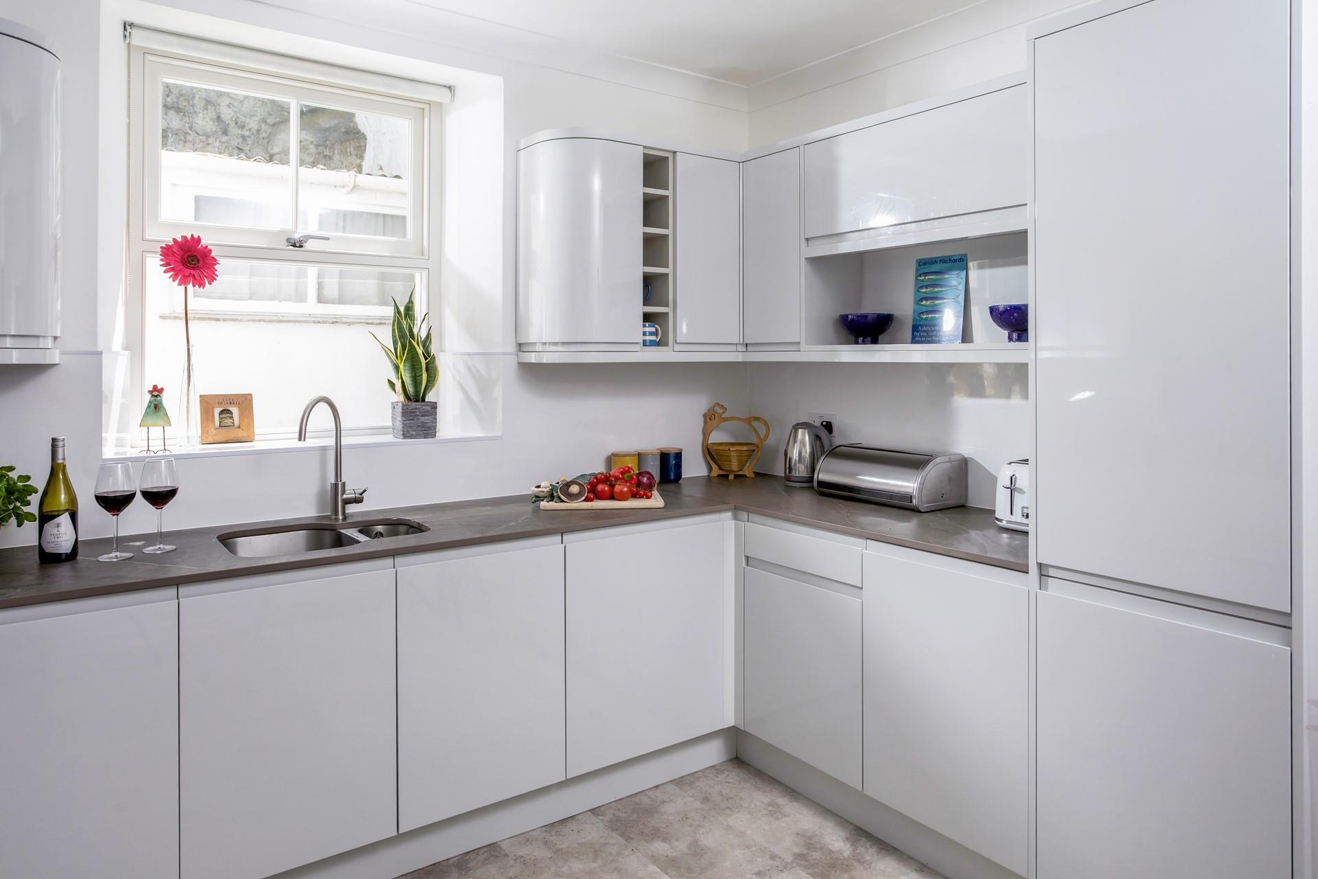 The kitchen is modern with plenty of worktop space.