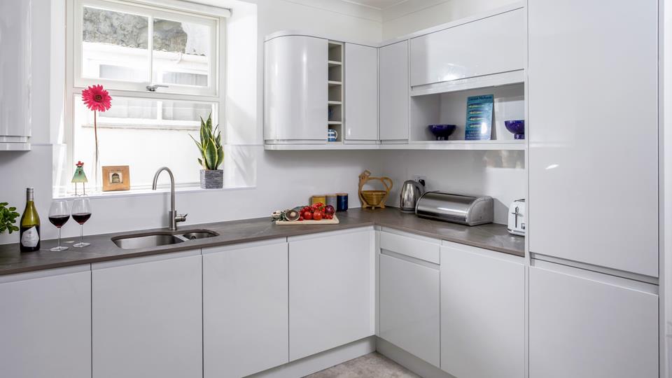The kitchen is modern with plenty of worktop space.
