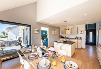 The open-plan kitchen and dining area are filled with natural light.