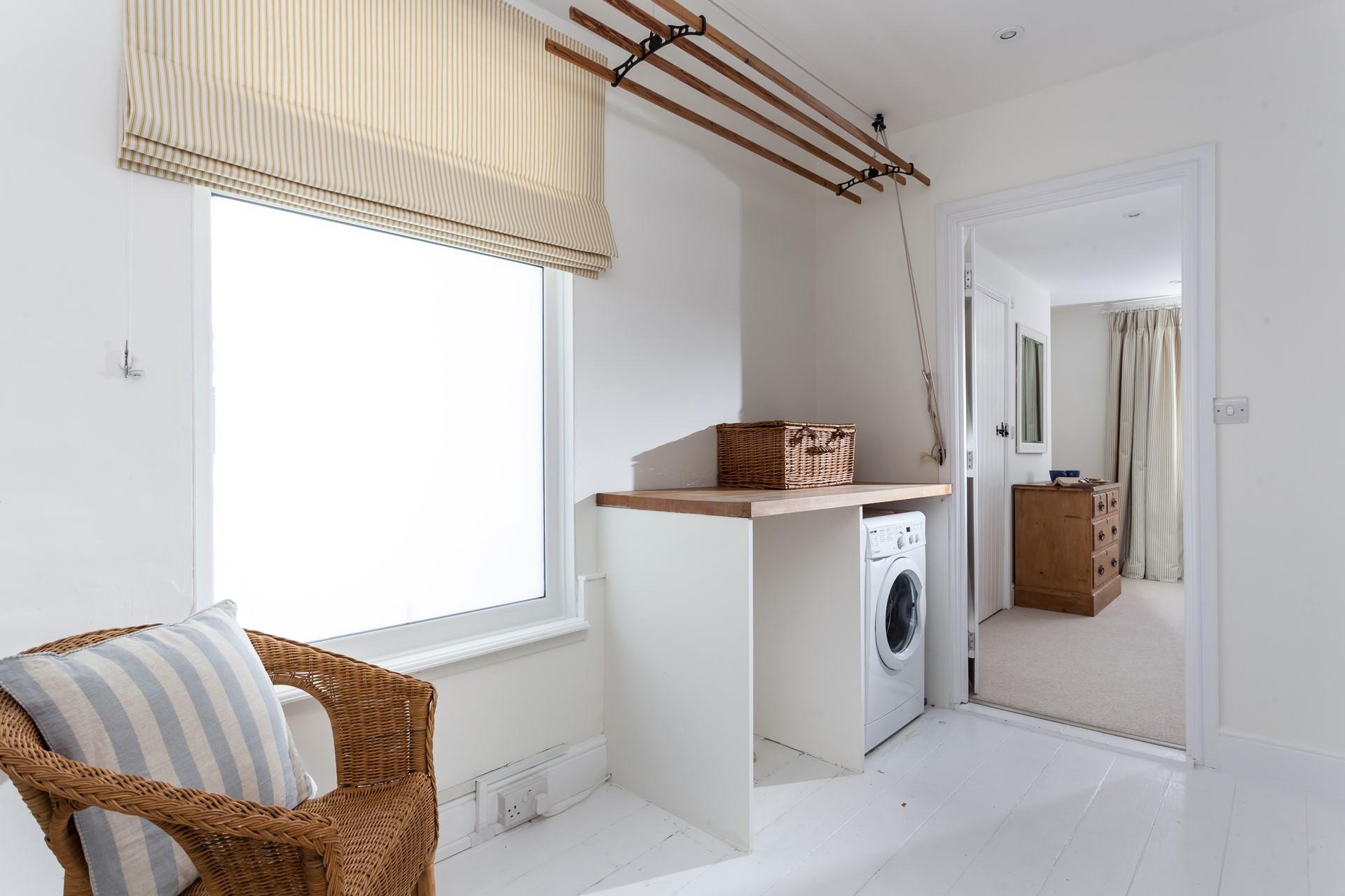 There is a washing machine in the utility area for washing off beach clothes.