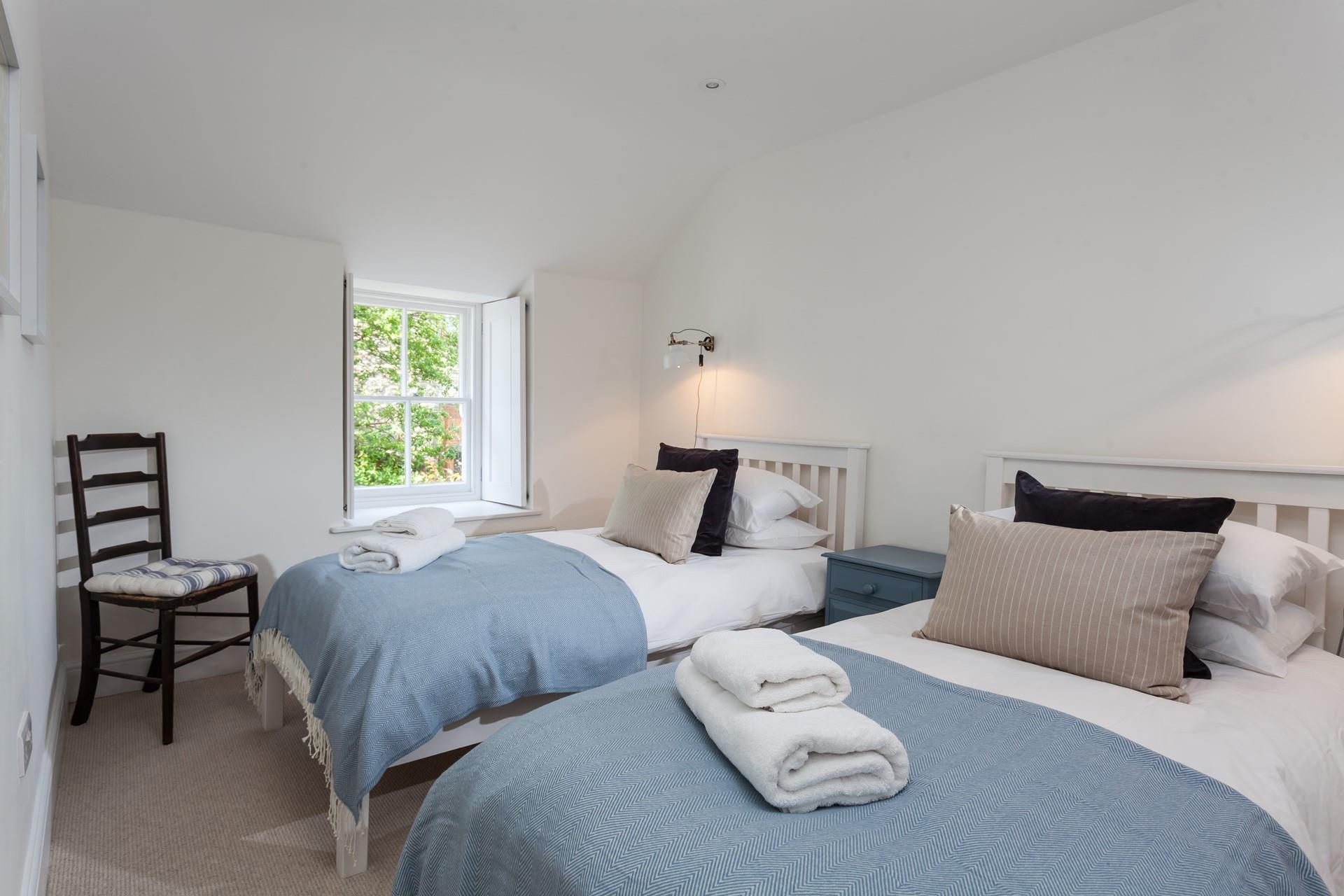 Neutral tones create a calming space to unwind on the soft sheets.