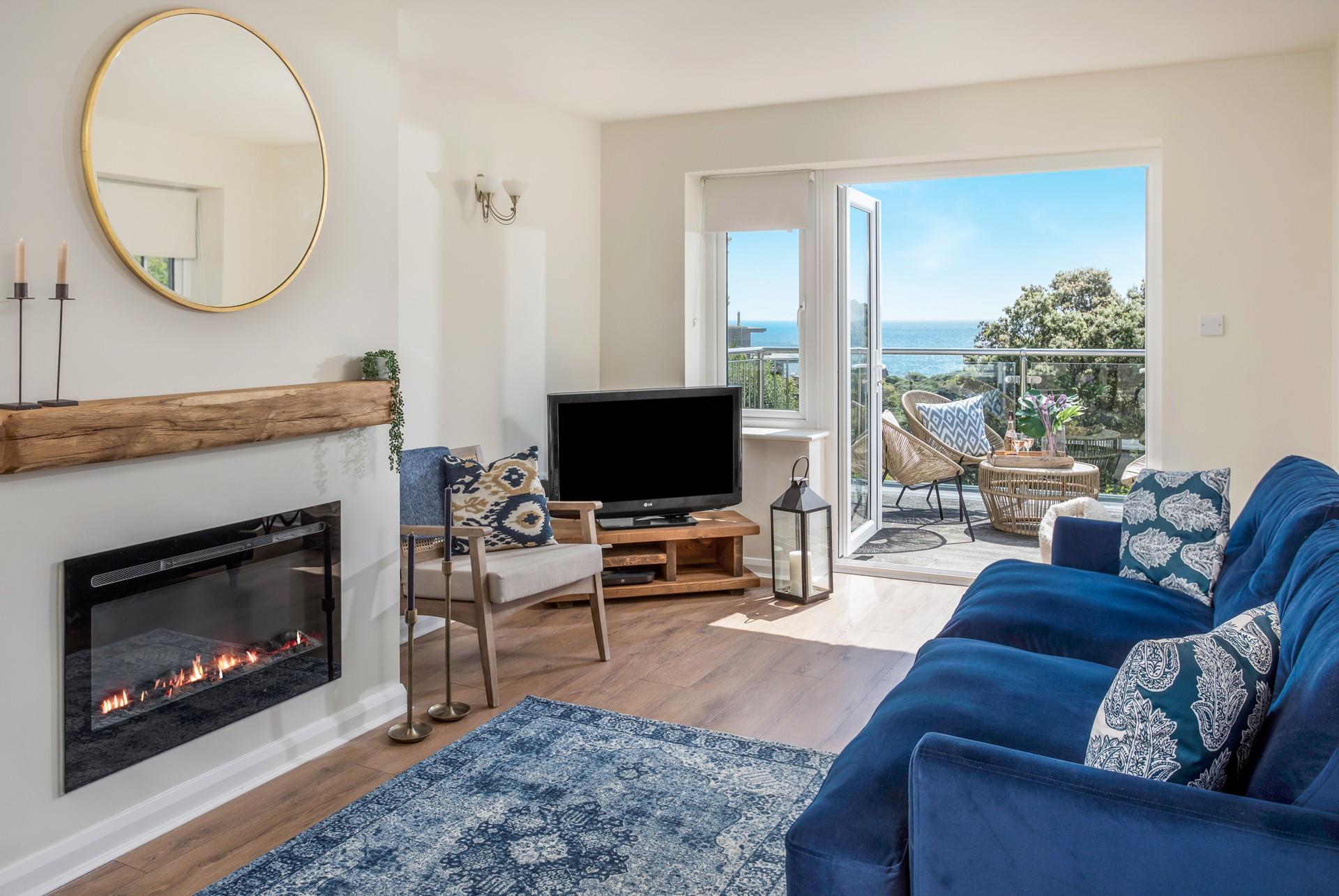 The sitting room is stylish with comfortable furnishings and a flame effect fire.