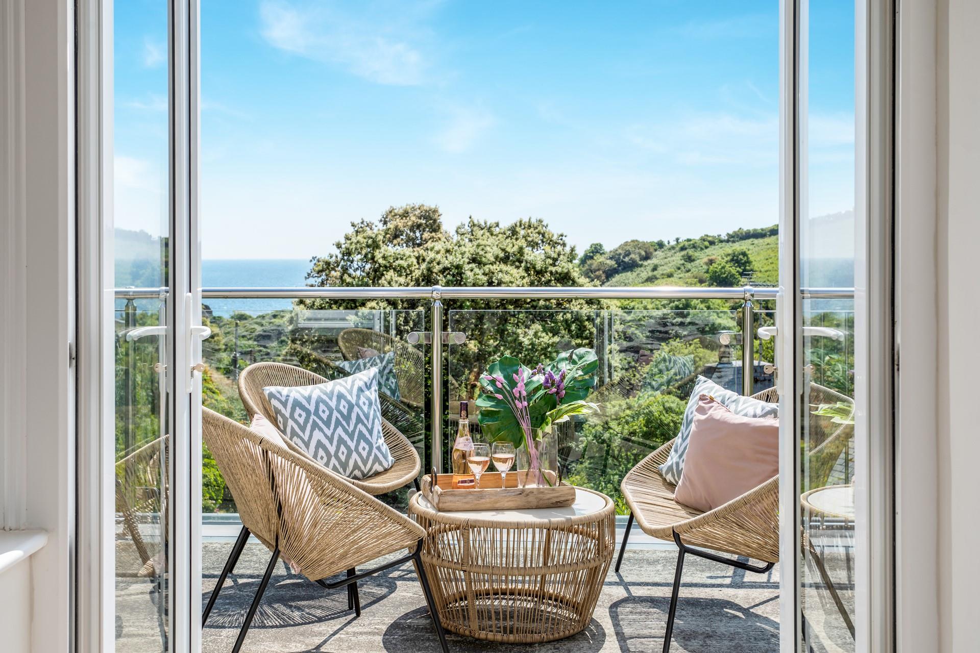 Watch the sea glisten in the sun as you sip a cold G&T.