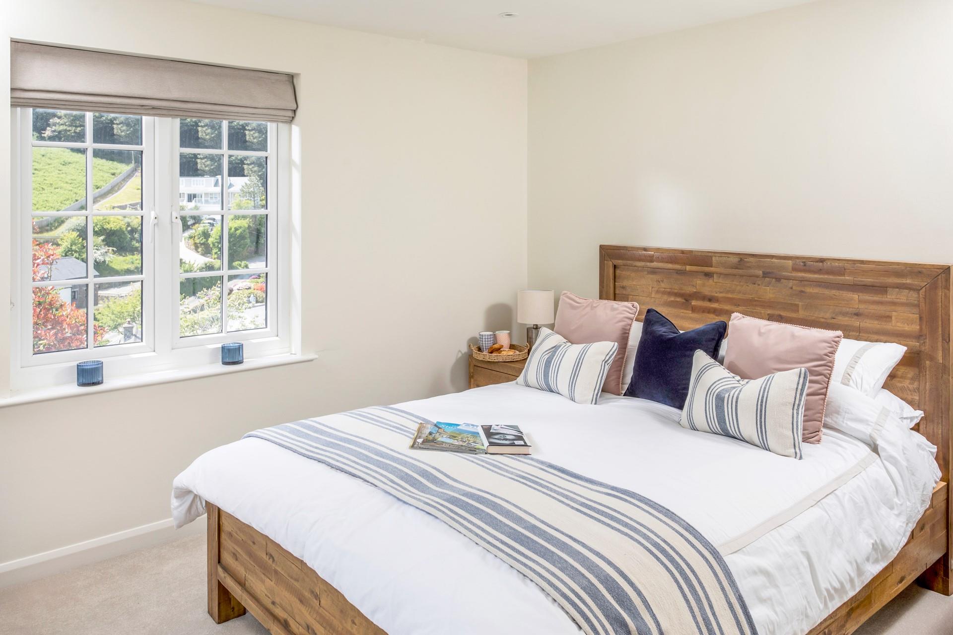 Bed 1 has a spacious king size bed with soft sheets and plump pillows.