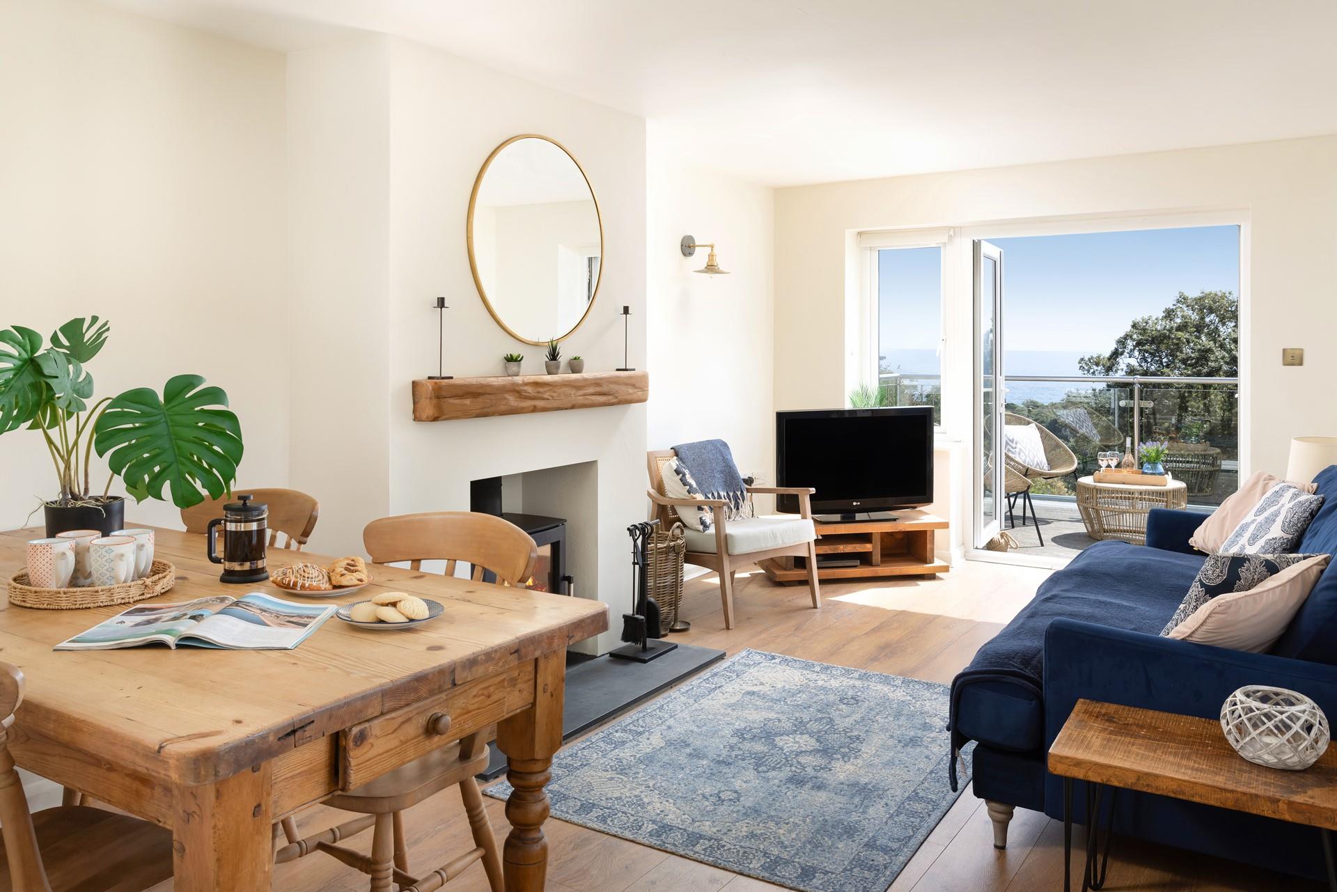 The sitting room is stylish with comfortable furnishings and cosy woodburner.