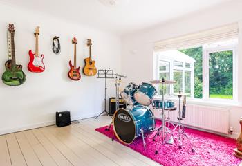 The music room features a guitar, drums, piano and microphone!