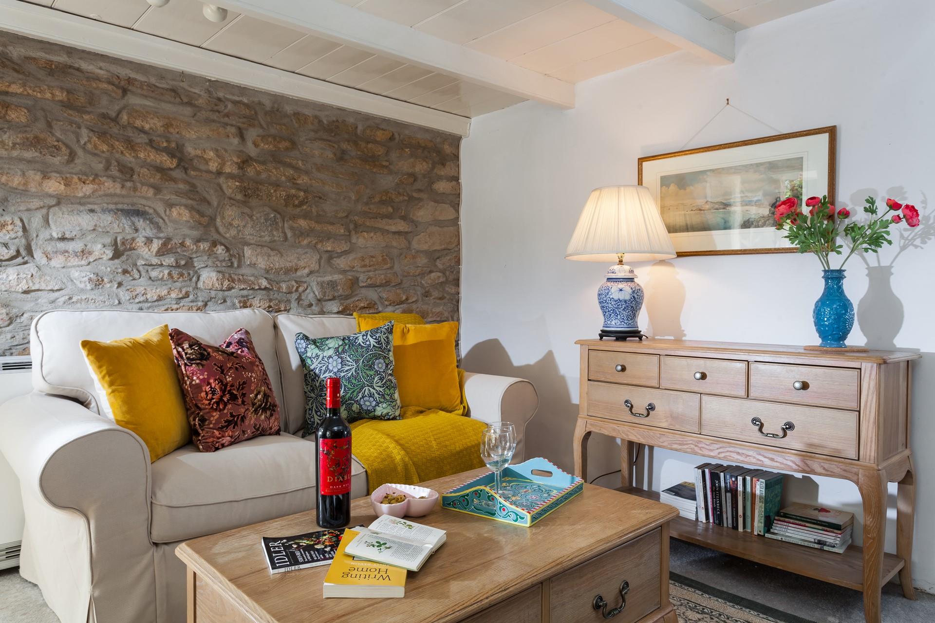 The cottage retains some original features such as the granite stone wall and fireplace.