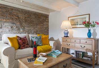 The cottage retains some original features such as the granite stone wall and fireplace.