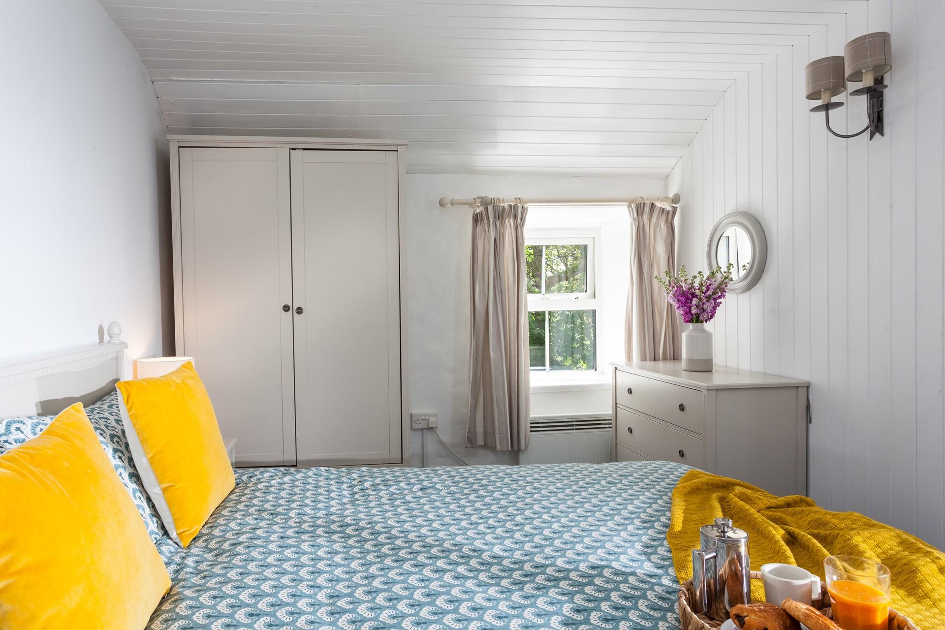 The bedrooms are decorated with natural furnishings with a pop of colour with cushions.