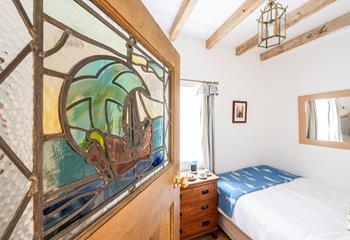 We love the stained glass door feature leading into bedroom 1.