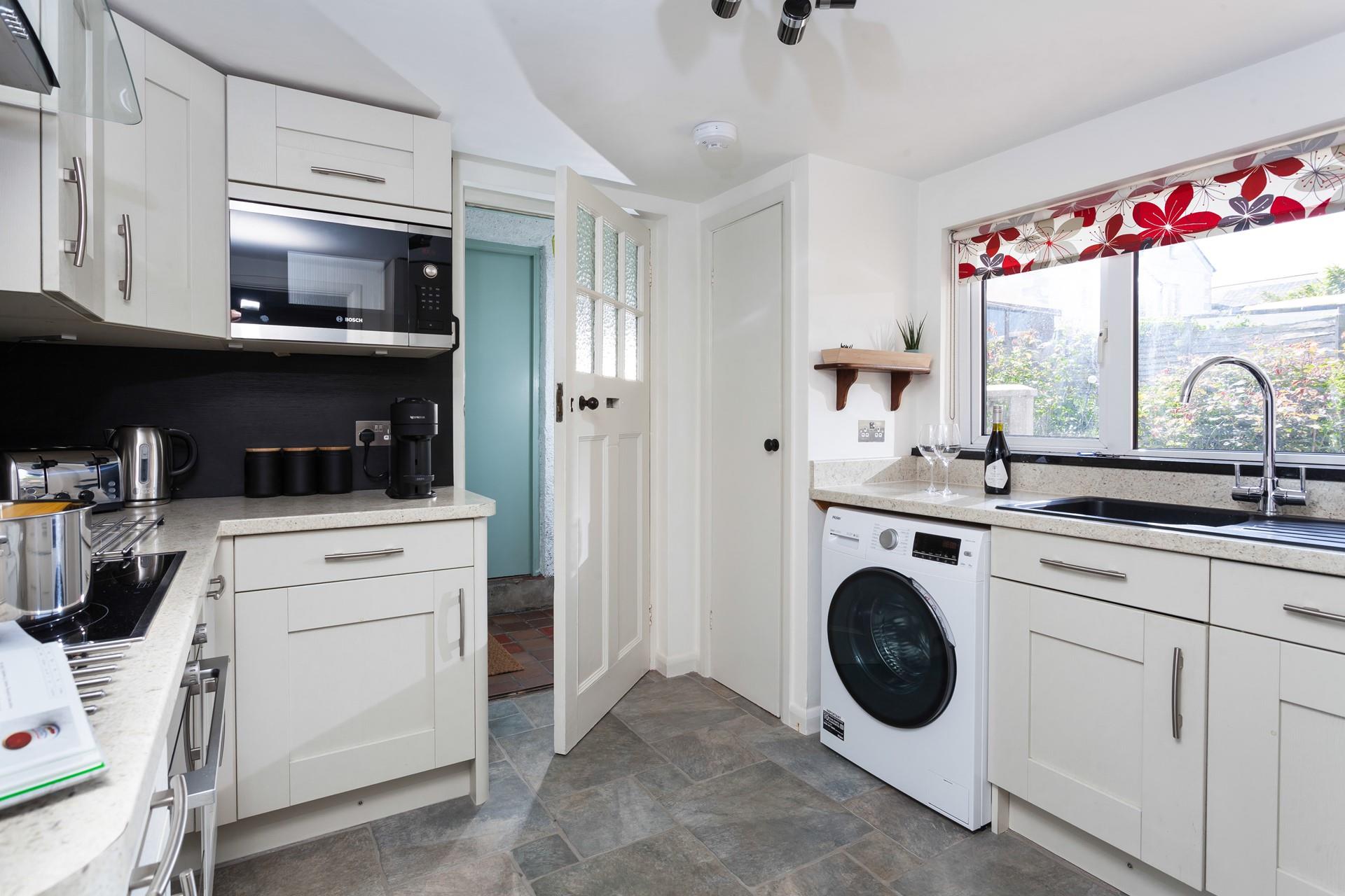 The kitchen is sleek and well-equipped with all you need for your stay.