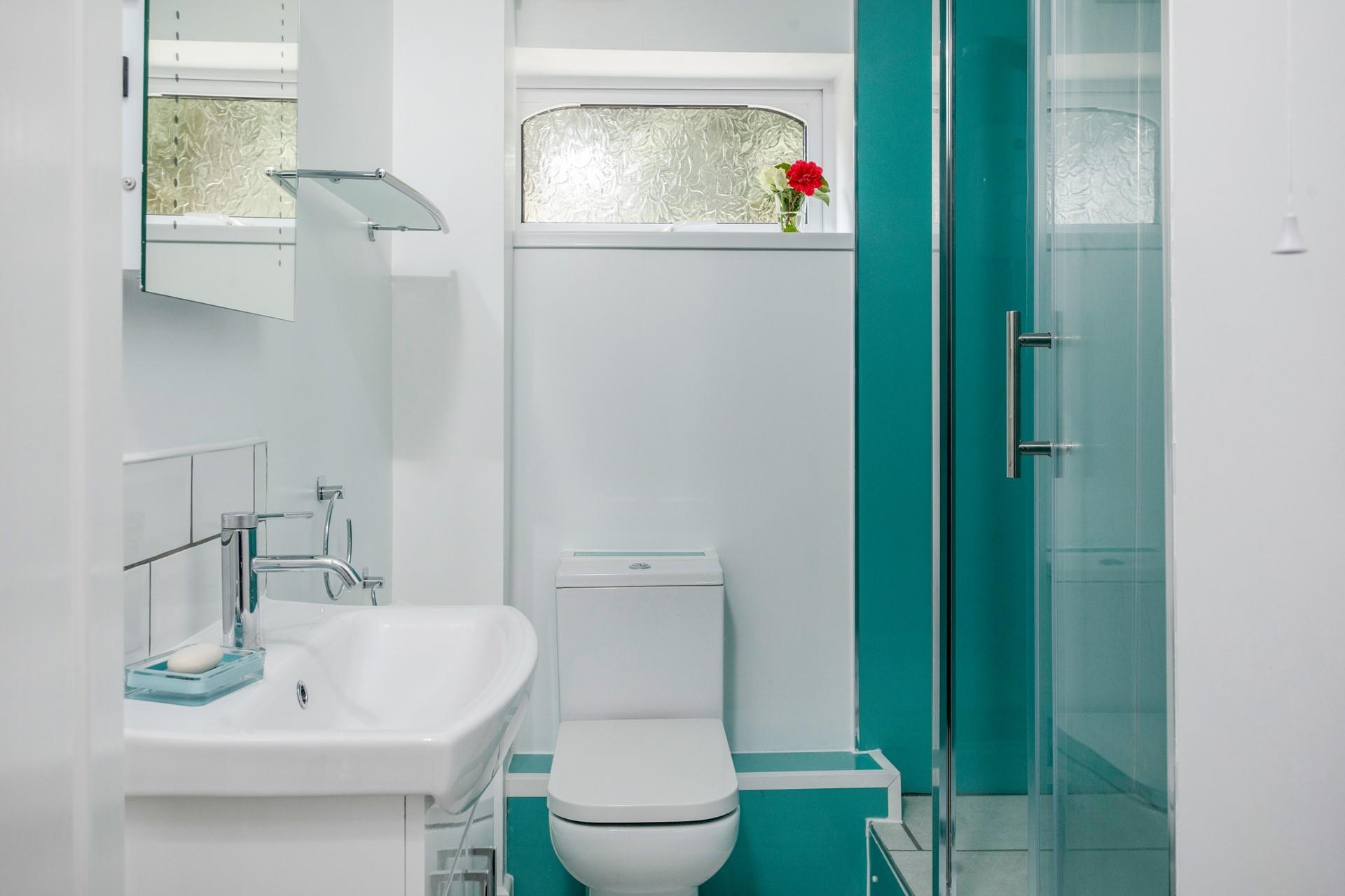 Wash off sandy toes in the shower room after a day on Castle Beach, just moments away.