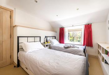 Bedroom 3 overlooks the garden and offers a comfortable space for adults or children.