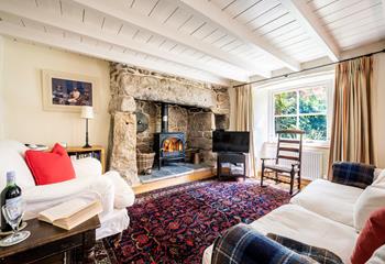 Curl up together in front of the cosy woodburner.