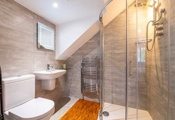 The ensuite shower room is stylish and modern with added luxuries such as the light-up mirror and heated towel rail.