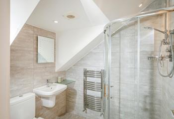 The ensuite shower room is stylish and modern with added luxuries such as the light-up mirror and heated towel rail.