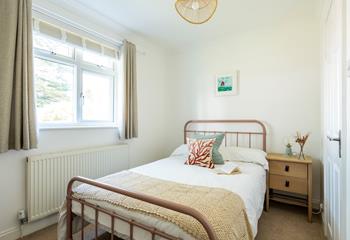 Bedroom 4 has a double bed and an en suite and is decorated in neutral tones.