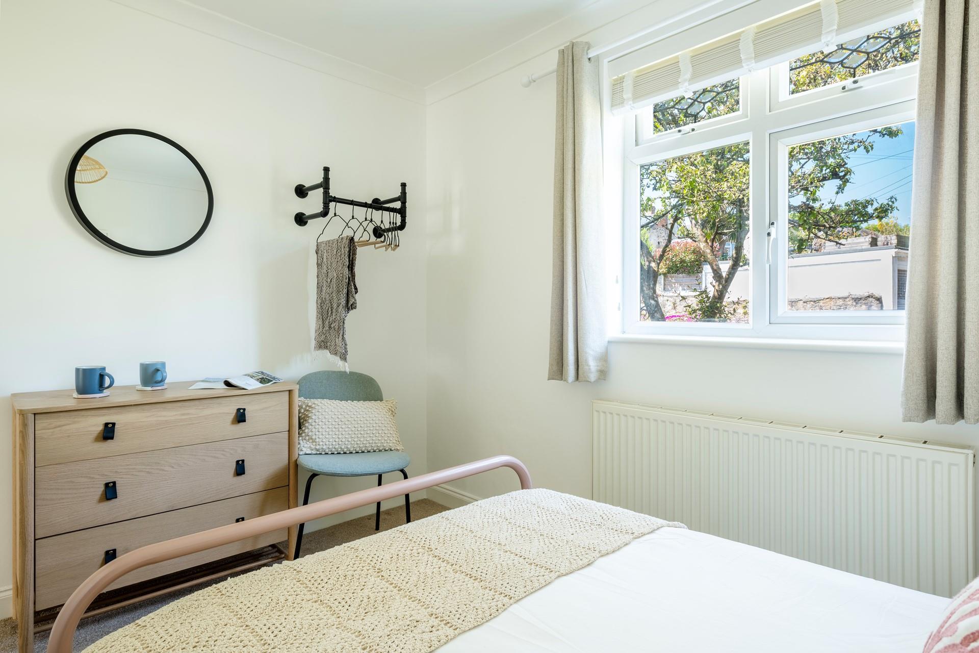 There is an open hanging space and a chest of drawers in bedroom 4.