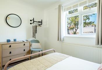 There is an open hanging space and a chest of drawers in bedroom 4.